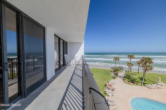 balcony with a water view and a beach view