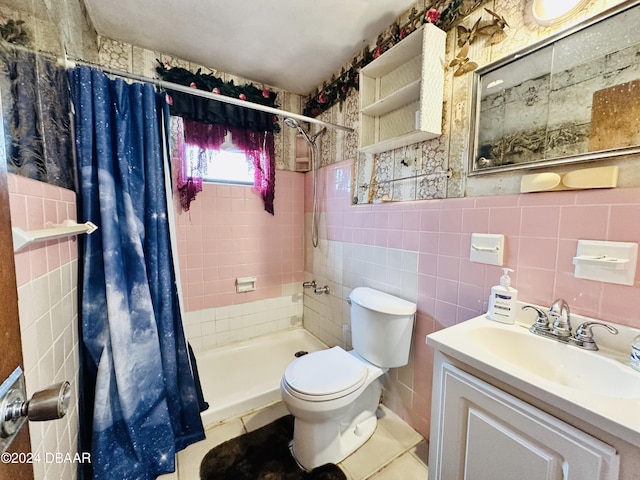 bathroom with toilet, vanity, tile walls, and walk in shower