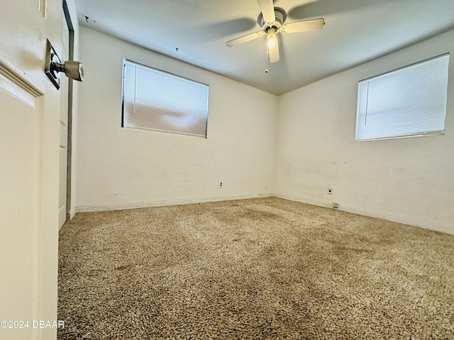 spare room with carpet flooring and ceiling fan