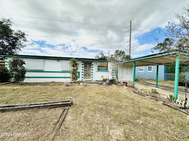 single story home featuring a front yard and a carport