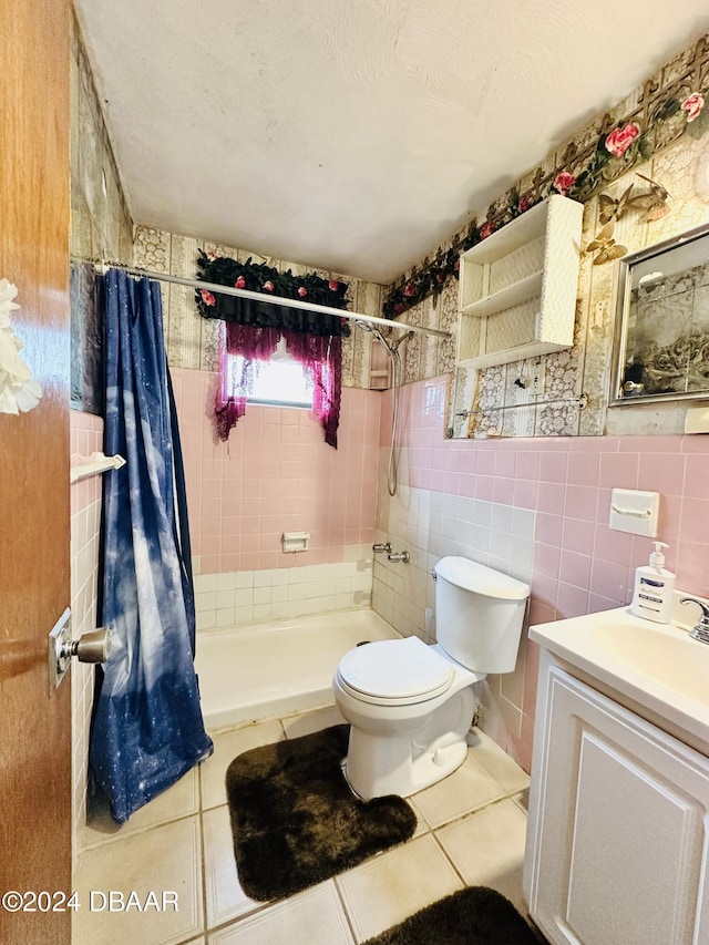 bathroom featuring tile patterned flooring, vanity, tile walls, and walk in shower