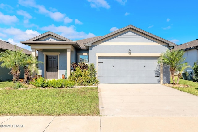 single story home with an attached garage, driveway, a front yard, and stucco siding