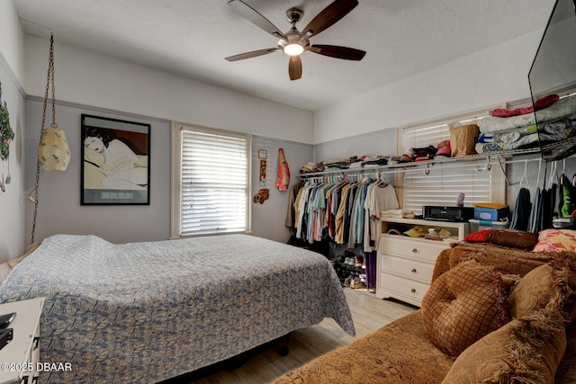 bedroom featuring ceiling fan and light hardwood / wood-style flooring