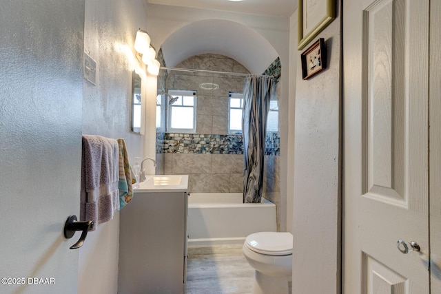 full bathroom with toilet, vanity, shower / bathtub combination with curtain, and hardwood / wood-style floors