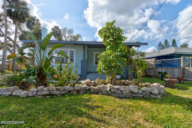 rear view of house featuring a yard