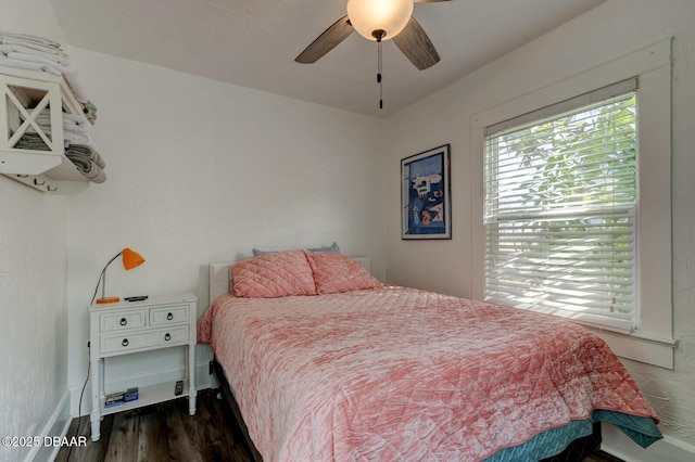 bedroom with ceiling fan and dark hardwood / wood-style flooring