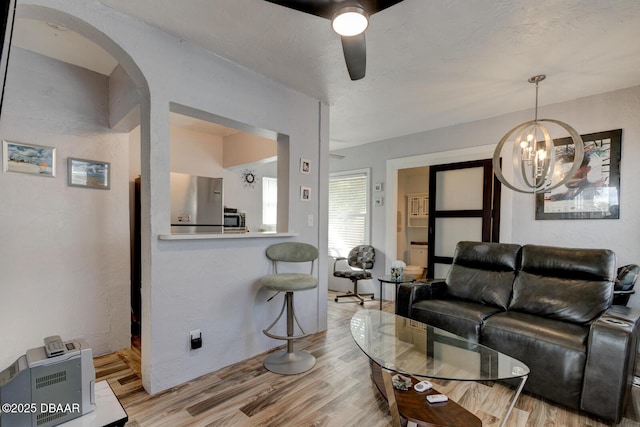 living room featuring ceiling fan and light hardwood / wood-style flooring