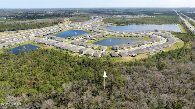 drone / aerial view with a residential view and a water view