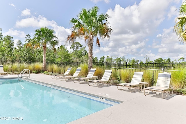 community pool featuring fence and a patio