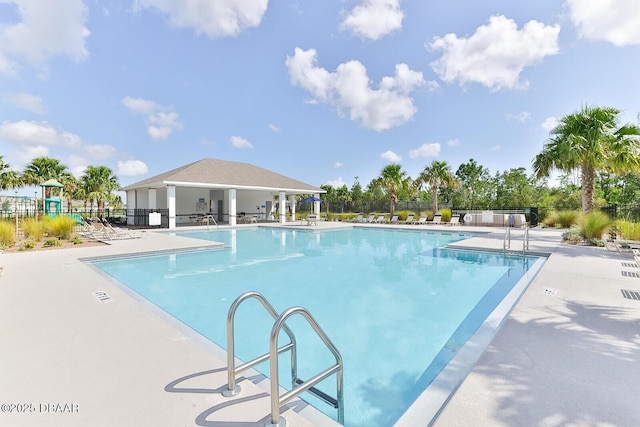 pool featuring a patio area and fence