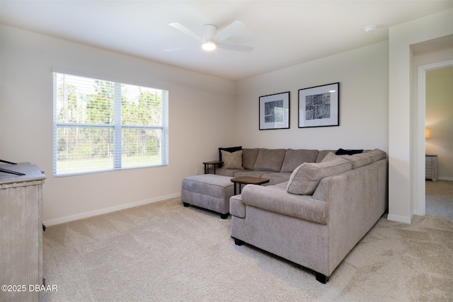 living room with light carpet, ceiling fan, and baseboards