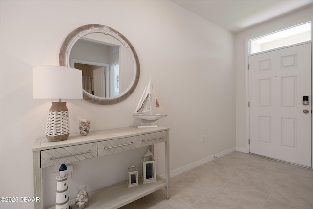 entrance foyer with light tile patterned floors and baseboards