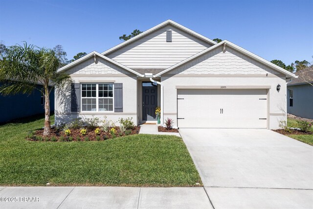 ranch-style home featuring a front yard, concrete driveway, and an attached garage