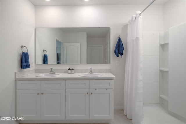 bathroom with curtained shower, tile patterned flooring, a sink, and double vanity