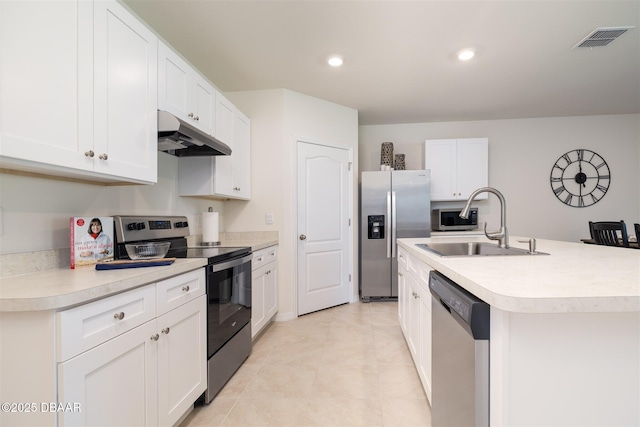 kitchen featuring under cabinet range hood, stainless steel appliances, a sink, visible vents, and light countertops