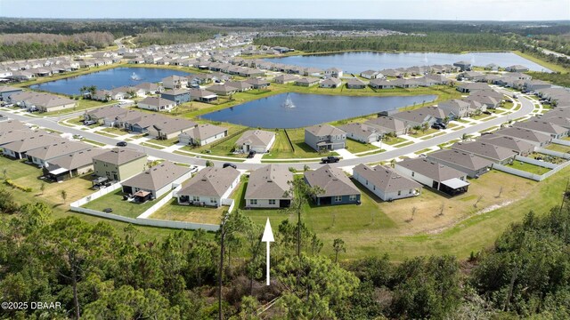 birds eye view of property featuring a water view and a residential view