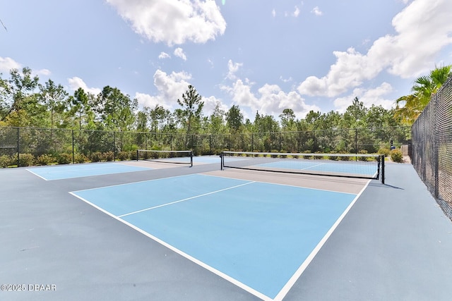 view of sport court featuring fence