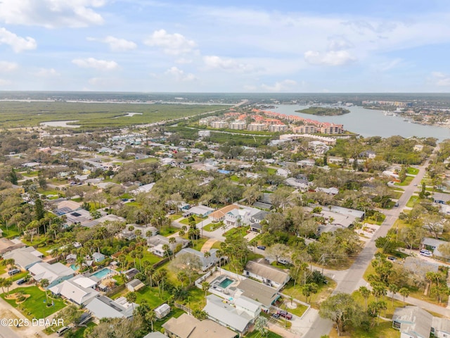 drone / aerial view featuring a residential view and a water view