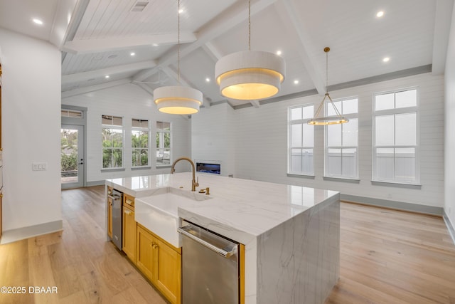 kitchen featuring a sink, light wood finished floors, vaulted ceiling with beams, a large fireplace, and dishwasher