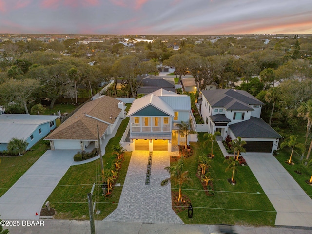 aerial view at dusk featuring a residential view