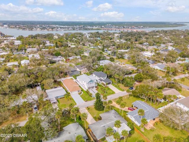 drone / aerial view with a residential view and a water view