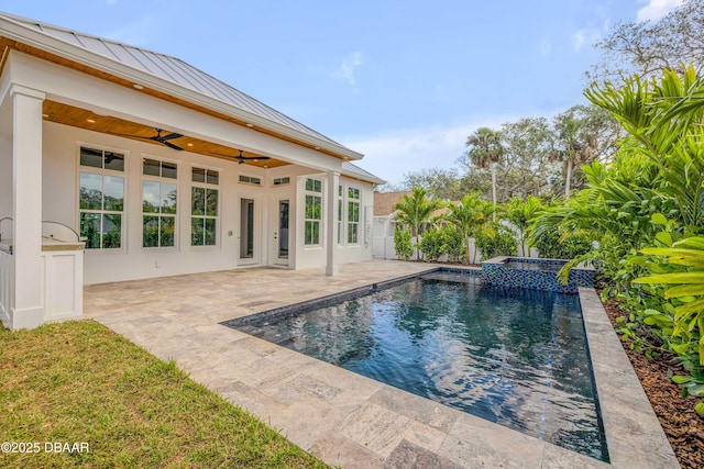 outdoor pool with fence, ceiling fan, and a patio
