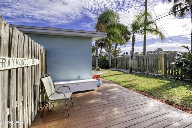 wooden deck featuring a lawn