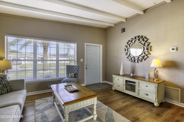 living room with dark hardwood / wood-style flooring and beam ceiling