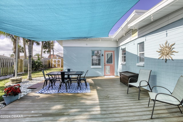 wooden deck with a storage shed