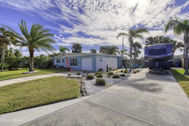 view of front of home featuring a garage and a front yard