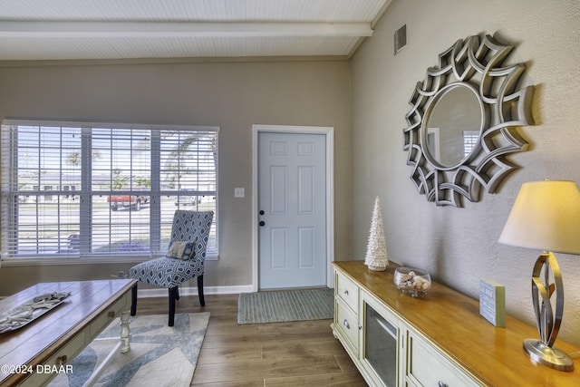 entryway featuring hardwood / wood-style flooring, plenty of natural light, and beamed ceiling