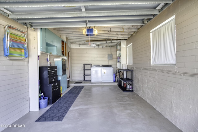 garage with a garage door opener and washing machine and clothes dryer