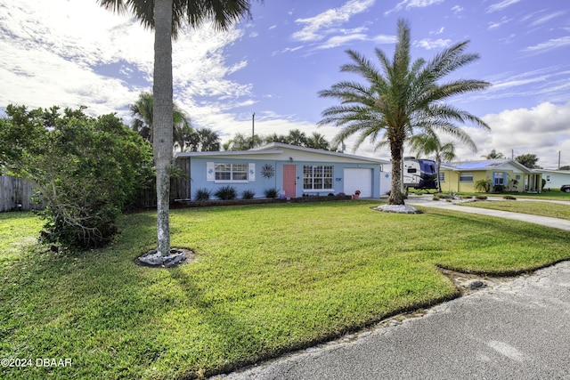 single story home with a front lawn and a garage