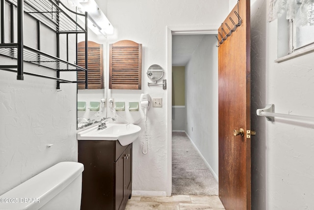 bathroom featuring vanity and toilet