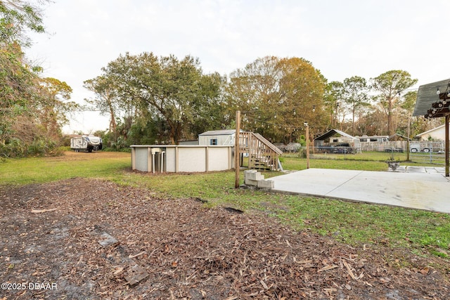 view of yard with a swimming pool and a patio