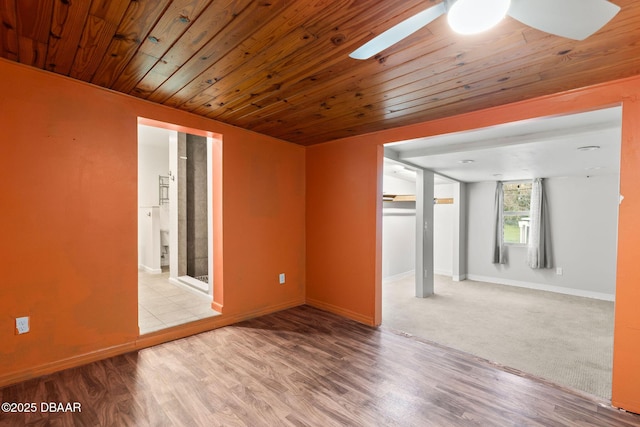 empty room with wood ceiling, light hardwood / wood-style floors, and ceiling fan