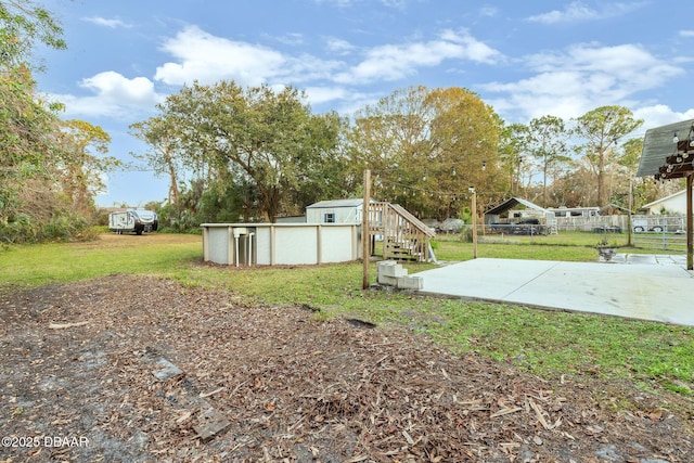 view of yard featuring a swimming pool and a patio area