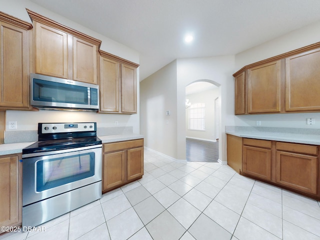 kitchen featuring stainless steel appliances and light tile patterned flooring