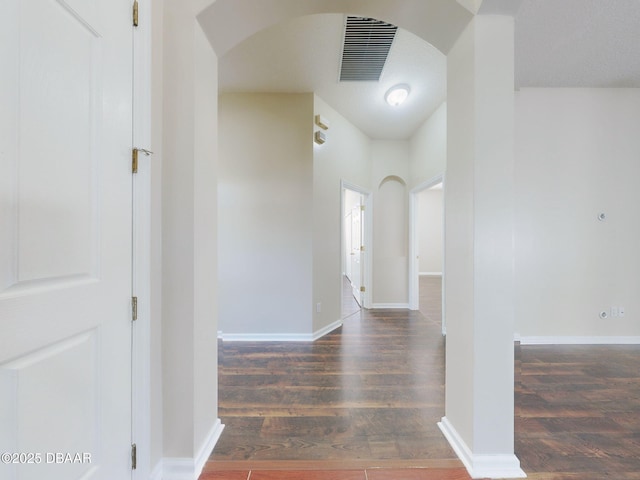 hallway featuring dark wood-type flooring