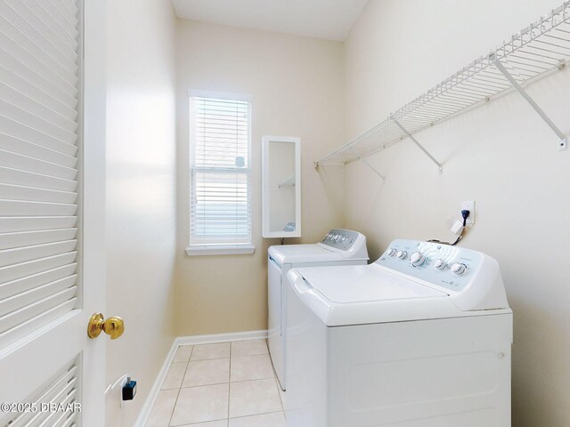 kitchen with light tile patterned flooring, stainless steel dishwasher, and sink