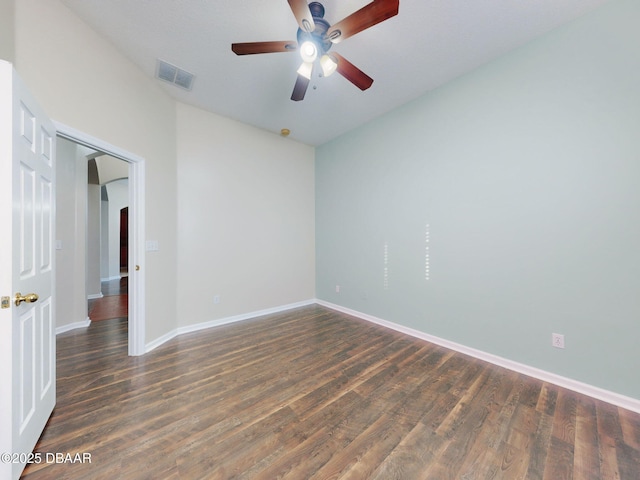 unfurnished room featuring ceiling fan with notable chandelier and dark hardwood / wood-style floors