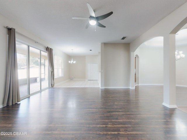 unfurnished room with dark hardwood / wood-style flooring, ceiling fan with notable chandelier, and a textured ceiling