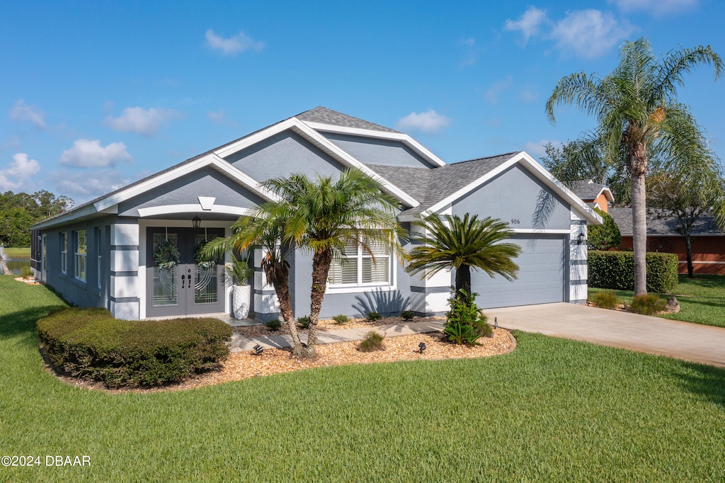 view of front facade with a garage and a front lawn