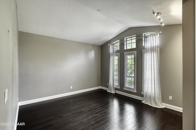 2809 Oakgrove Ave, Saint Augustine, FL 32092 - spare room with dark wood-type flooring, lofted ceiling, and a textured ceiling