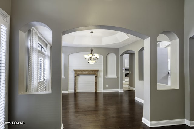 2809 Oakgrove Ave, Saint Augustine, FL 32092 - entrance foyer with dark wood-type flooring, plenty of natural light, a tray ceiling, and a chandelier