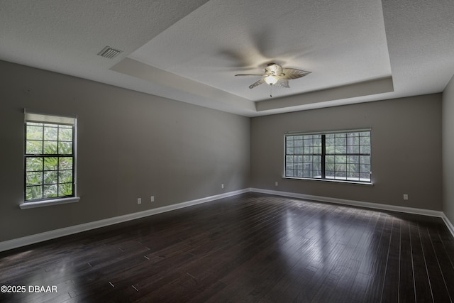 2809 Oakgrove Ave, Saint Augustine, FL 32092 - empty room featuring a raised ceiling, plenty of natural light, a textured ceiling, ceiling fan, and dark wood-style floors