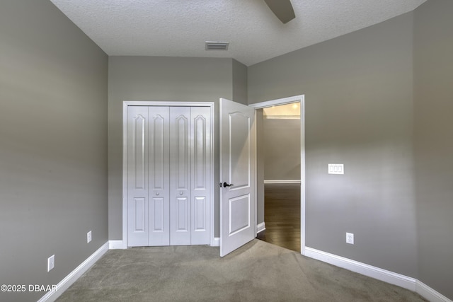 2809 Oakgrove Ave, Saint Augustine, FL 32092 - unfurnished bedroom featuring a textured ceiling, a closet, carpet floors, and a ceiling fan
