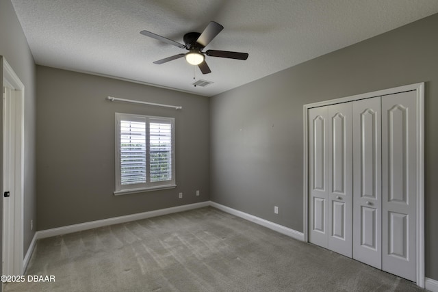 2809 Oakgrove Ave, Saint Augustine, FL 32092 - unfurnished bedroom with carpet, a closet, a textured ceiling, and ceiling fan