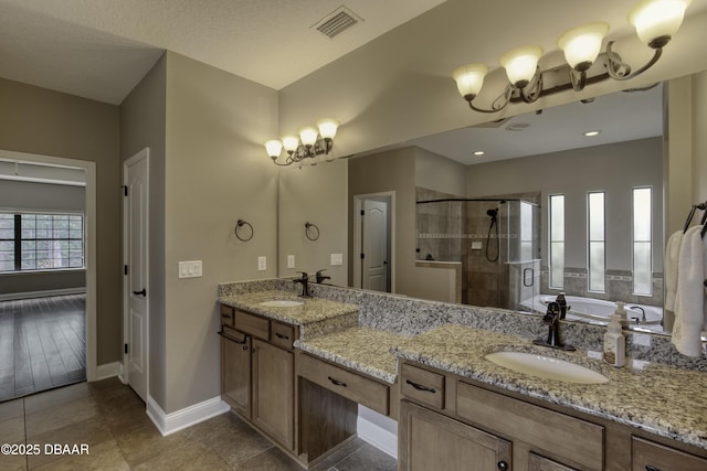 2809 Oakgrove Ave, Saint Augustine, FL 32092 - bathroom featuring a stall shower, double vanity, a garden tub, a chandelier, and tile patterned flooring