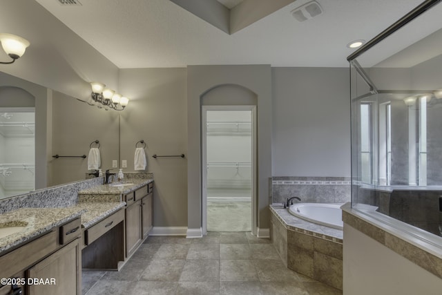 2809 Oakgrove Ave, Saint Augustine, FL 32092 - bathroom with a spacious closet, a bath, and double vanity